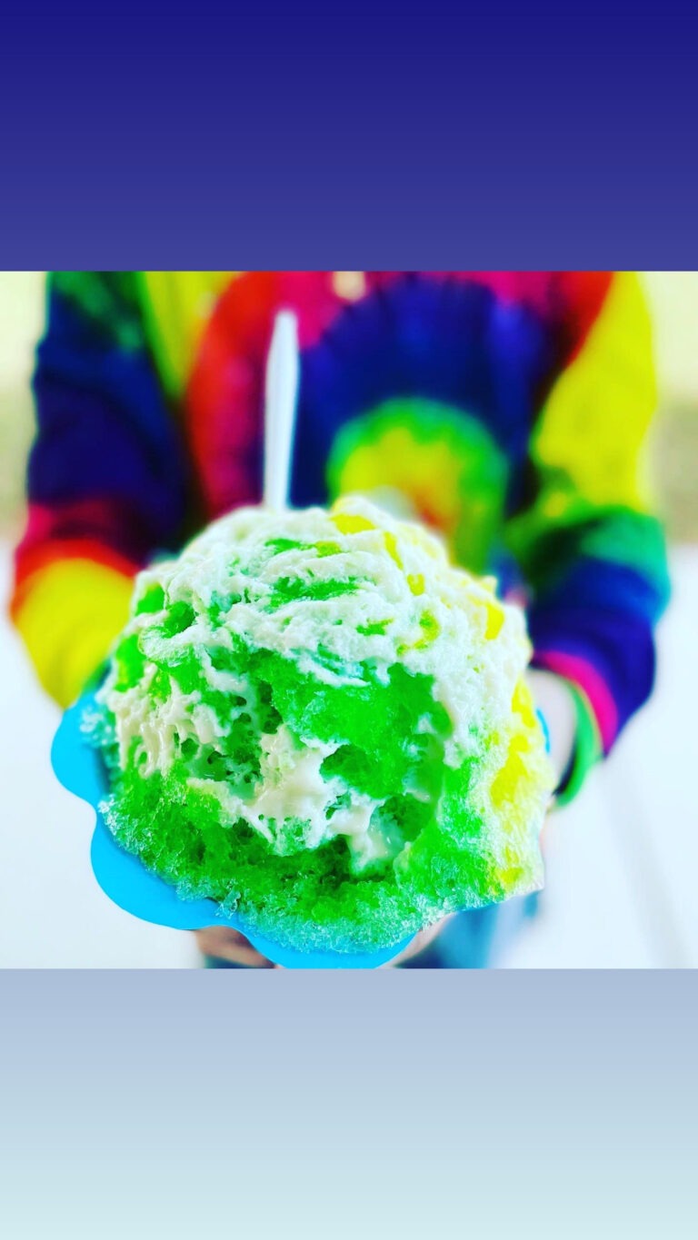 Shaved Ice green flavor with a person in a tie dye hoodie.