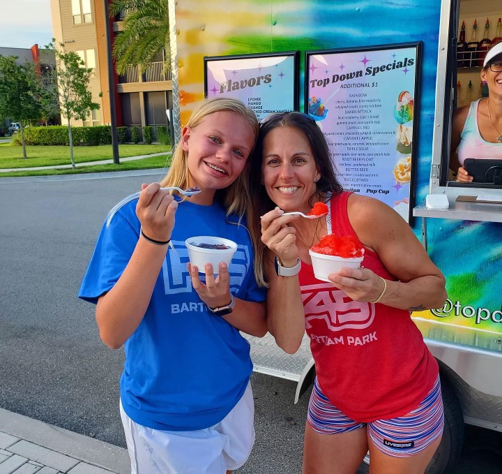 Two happy clients eating shaved ice.