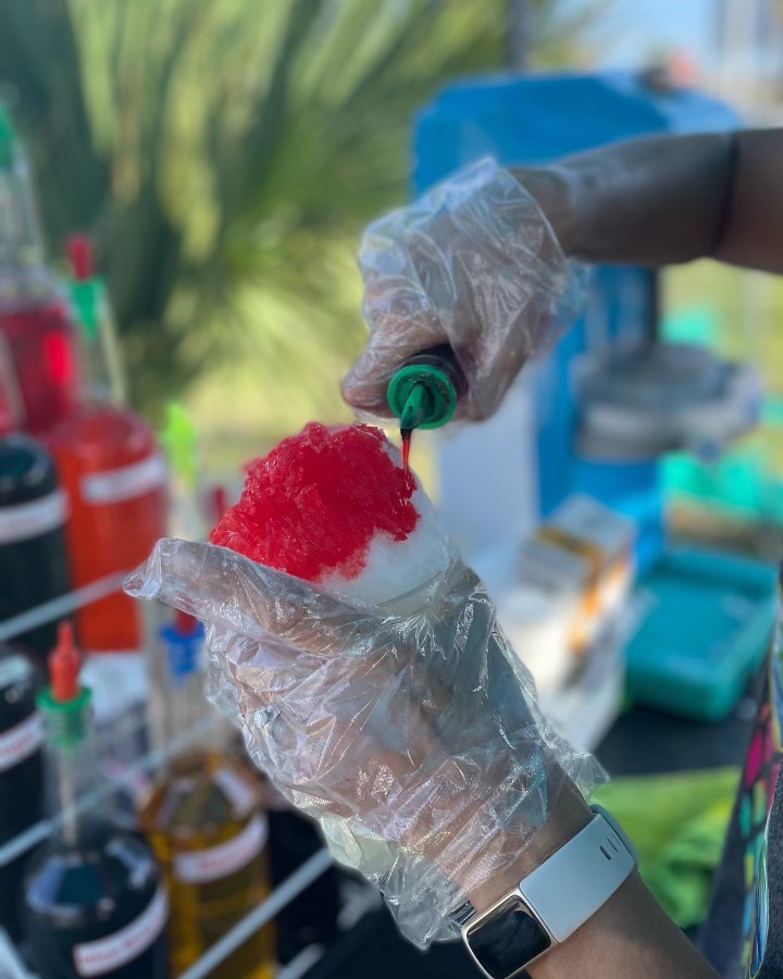 Pouring Red Flavoring on Shaved Ice