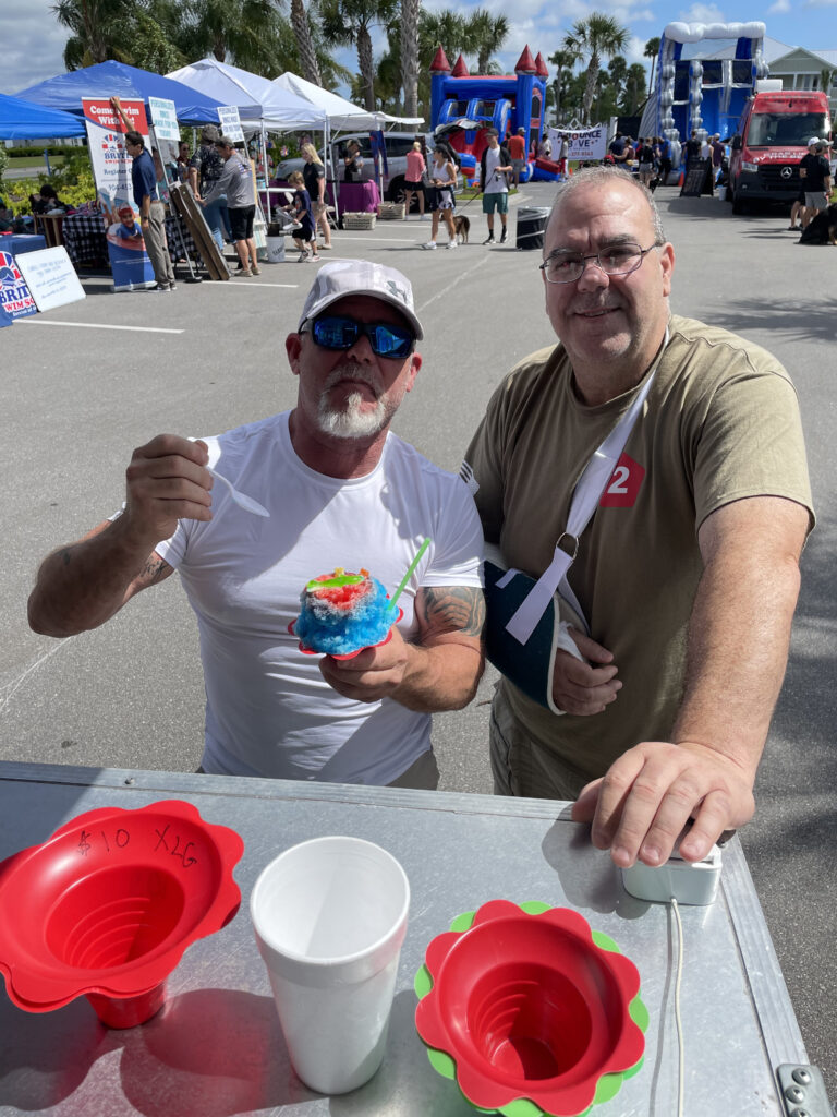 Two guys getting shaved ice